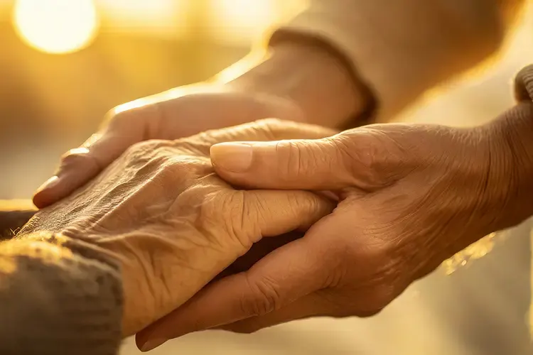 Two people holding hands in comfort