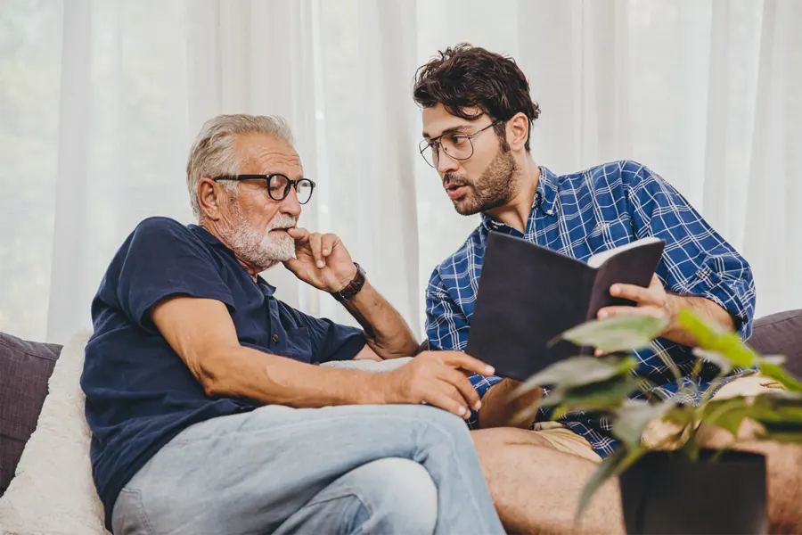 An older man and his son talking things over